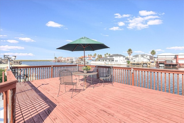 wooden terrace featuring a water view