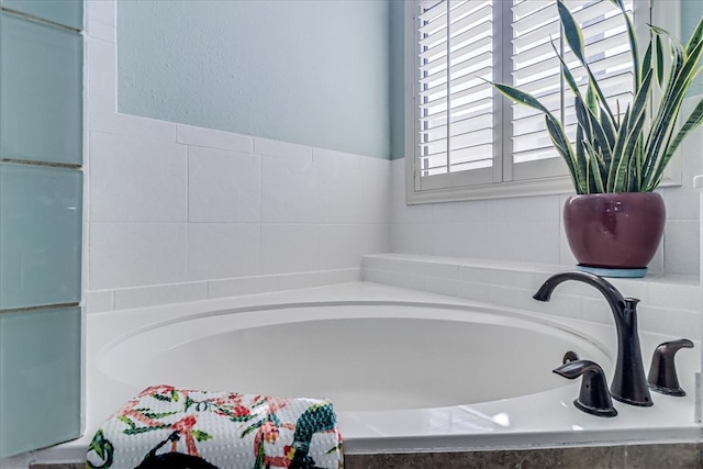 bathroom with tiled tub