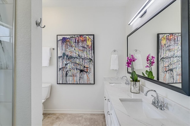 bathroom with tile patterned flooring, vanity, and toilet