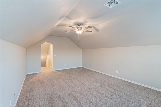 bonus room with ceiling fan, lofted ceiling, and light carpet