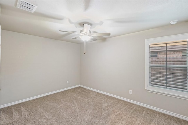 unfurnished room with ceiling fan and carpet