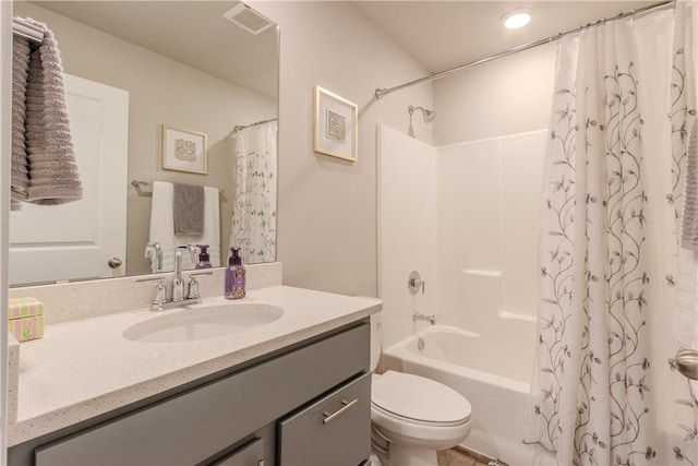 full bathroom featuring vanity, shower / tub combo, and toilet