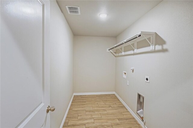 laundry room with gas dryer hookup, electric dryer hookup, washer hookup, and light hardwood / wood-style floors