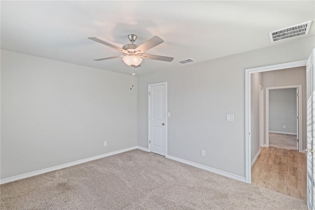 carpeted empty room featuring ceiling fan