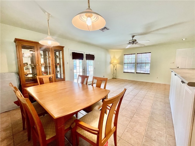 dining room with french doors, a healthy amount of sunlight, ceiling fan, and light tile patterned flooring