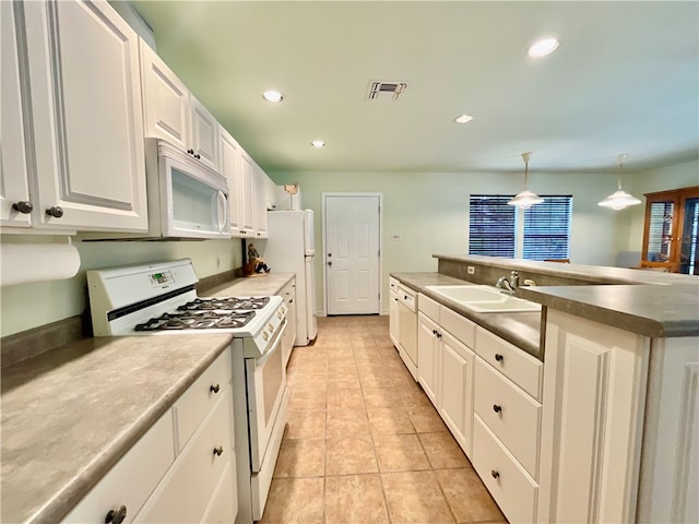 kitchen featuring pendant lighting, white appliances, sink, and white cabinets