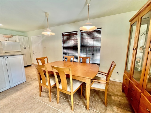 dining space featuring light tile patterned floors