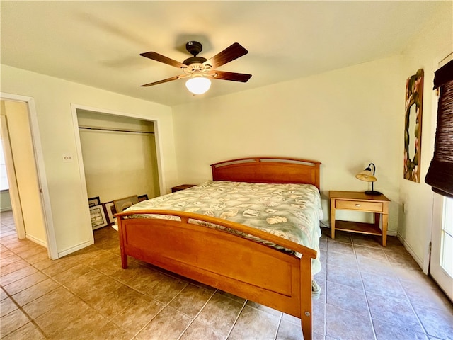 tiled bedroom featuring ceiling fan and a closet