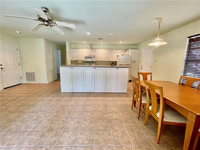 kitchen featuring white cabinets, light tile patterned floors, ceiling fan, pendant lighting, and white appliances