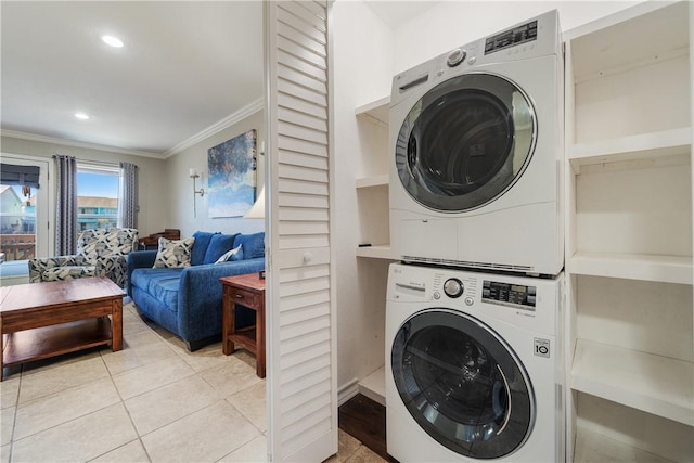 laundry room with light tile patterned floors, stacked washer and clothes dryer, ornamental molding, and recessed lighting