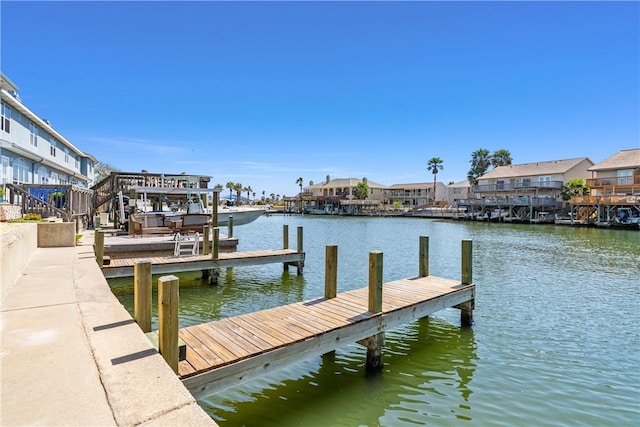 dock area featuring a residential view and a water view