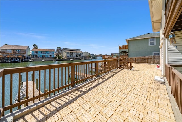 view of patio with a residential view and a water view