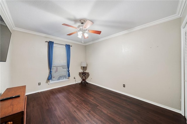 empty room featuring baseboards, wood finished floors, a ceiling fan, and ornamental molding