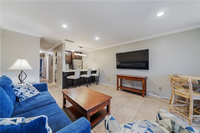 living area with light tile patterned floors, recessed lighting, visible vents, and ornamental molding