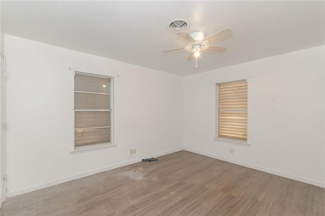 spare room featuring light hardwood / wood-style floors and ceiling fan