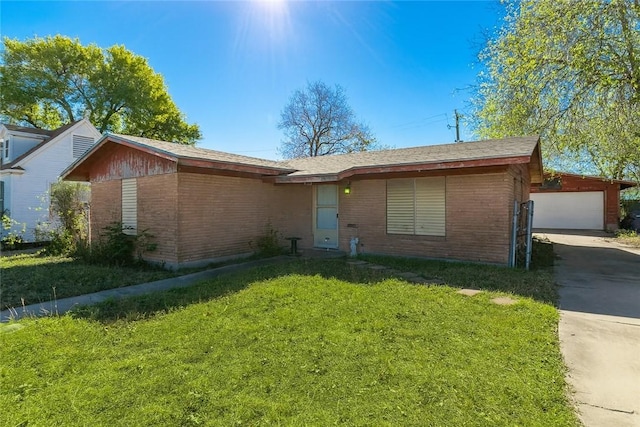 3709 S Saxet Dr, Corpus Christi, TX 78408 - view of front of home featuring brick siding, a front yard, concrete driveway, and an outdoor structure