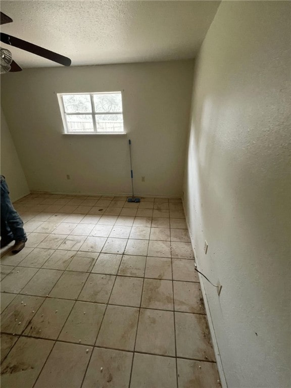 spare room with light tile patterned floors and ceiling fan