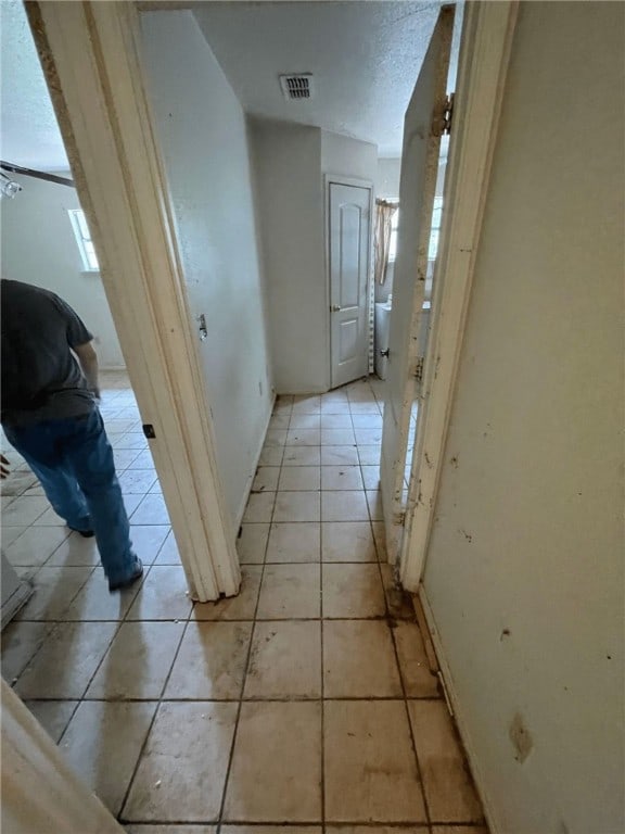 corridor featuring light tile patterned flooring