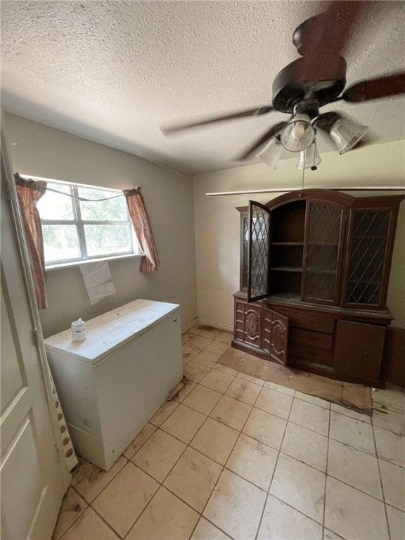 bathroom featuring tile patterned flooring, a textured ceiling, and ceiling fan