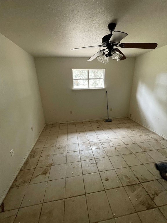 spare room featuring a textured ceiling and ceiling fan