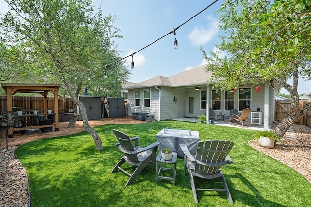 1962 Lighthouse Lakes Ln, Aransas Pass, TX 78336 - back of property with a fenced backyard, a storage shed, a yard, a patio area, and an outbuilding