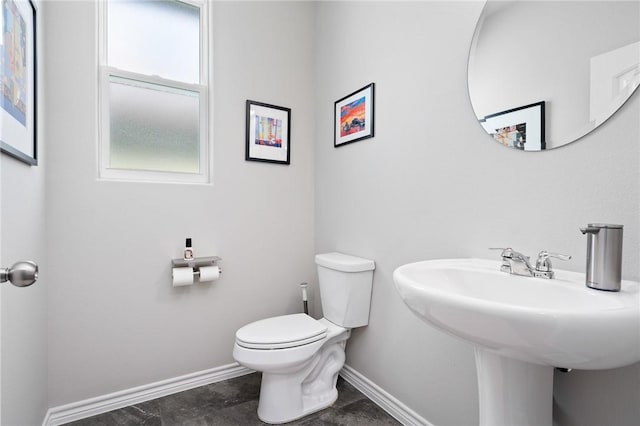 1962 Lighthouse Lakes Ln, Aransas Pass, TX 78336 - bathroom featuring toilet, baseboards, and a sink