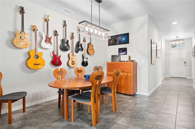 1962 Lighthouse Lakes Ln, Aransas Pass, TX 78336 - dining area featuring baseboards, visible vents, and an inviting chandelier