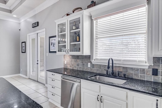 kitchen featuring sink, white cabinets, dishwasher, light tile patterned floors, and tasteful backsplash