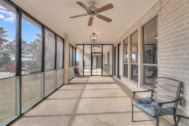 unfurnished sunroom with ceiling fan