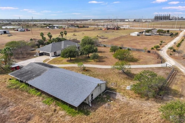 birds eye view of property with a rural view