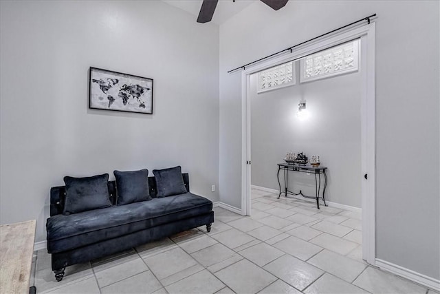 tiled living room with ceiling fan