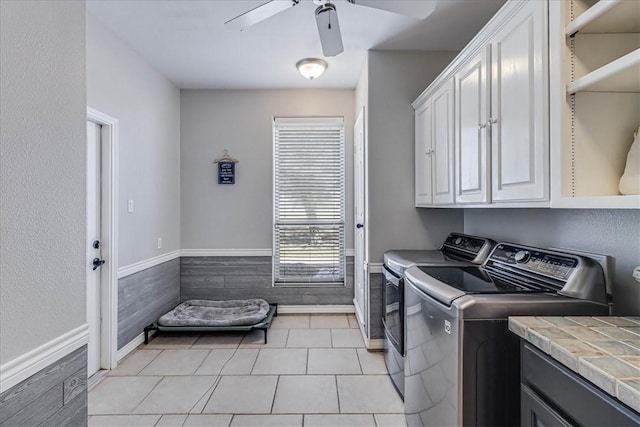 laundry room featuring washer and dryer, ceiling fan, cabinets, and light tile patterned floors