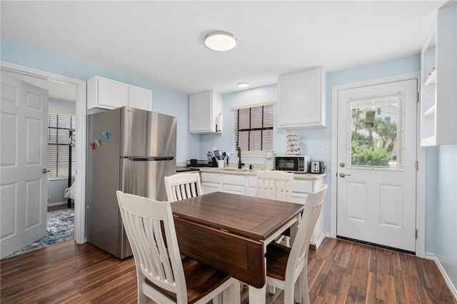 dining space with dark wood-style floors and baseboards