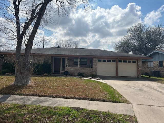 ranch-style house with a garage and central AC