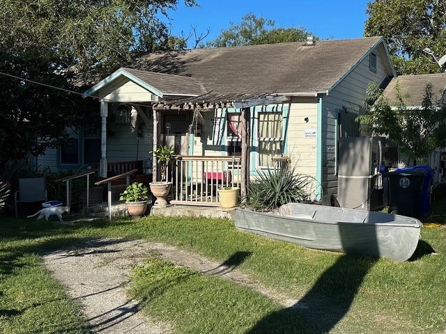 rear view of property with a yard