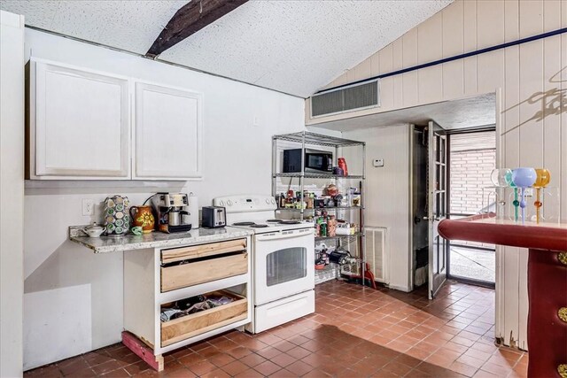 434 Cape Lookout Dr, Corpus Christi, TX 78412 - kitchen with light countertops, visible vents, vaulted ceiling, and white electric range