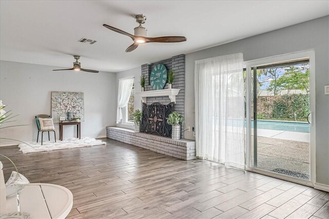 434 Cape Lookout Dr, Corpus Christi, TX 78412 - living room with wood finished floors, a wealth of natural light, visible vents, and ceiling fan