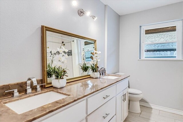 434 Cape Lookout Dr, Corpus Christi, TX 78412 - full bathroom featuring double vanity, a sink, toilet, and a stall shower