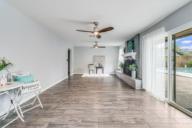 434 Cape Lookout Dr, Corpus Christi, TX 78412 - unfurnished living room with visible vents, baseboards, ceiling fan, wood finished floors, and a fireplace