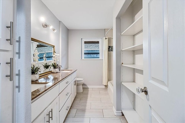 434 Cape Lookout Dr, Corpus Christi, TX 78412 - bathroom featuring toilet, baseboards, a sink, double vanity, and shower / bath combo