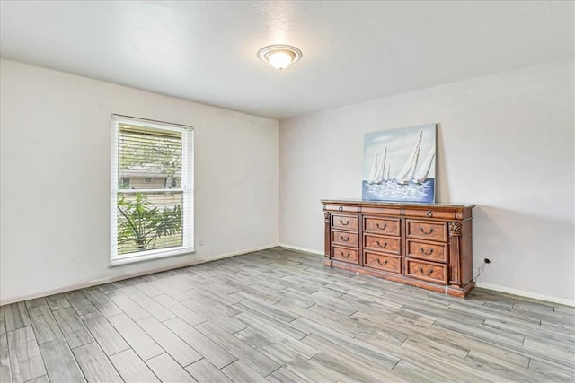 434 Cape Lookout Dr, Corpus Christi, TX 78412 - spare room featuring baseboards and light wood finished floors