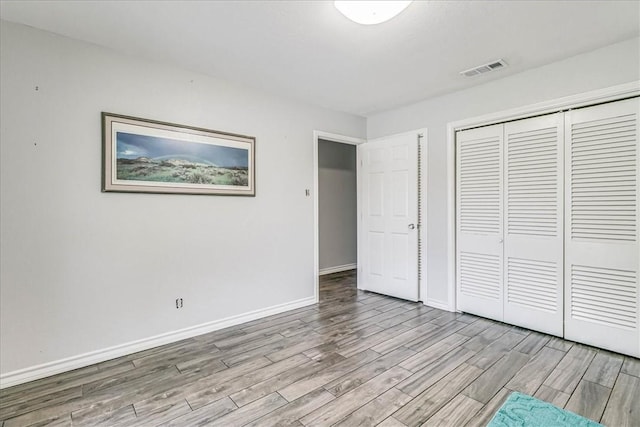 434 Cape Lookout Dr, Corpus Christi, TX 78412 - unfurnished bedroom with a closet, baseboards, visible vents, and wood finished floors