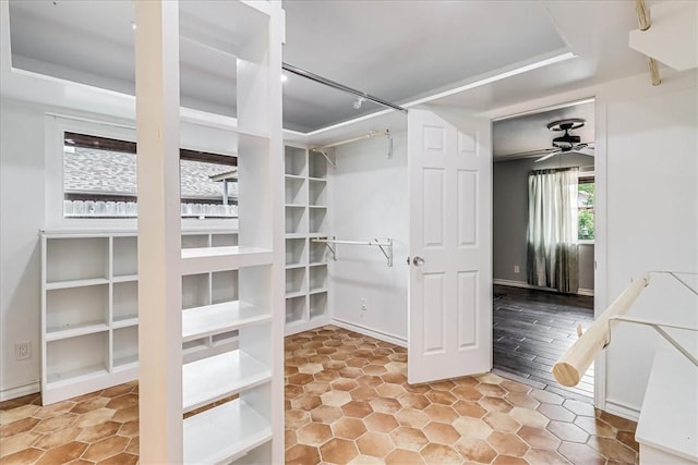 434 Cape Lookout Dr, Corpus Christi, TX 78412 - walk in closet with a tray ceiling, ceiling fan, and tile patterned flooring
