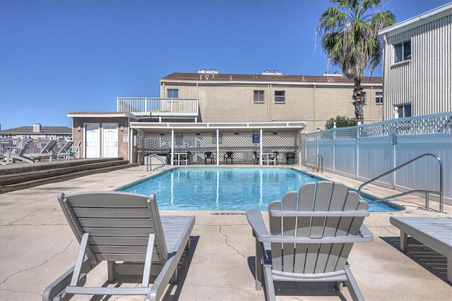 view of swimming pool featuring a patio area