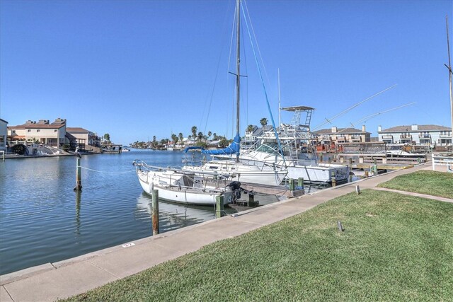 dock area with a water view and a lawn