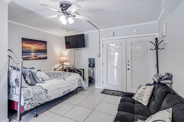 tiled bedroom with a closet, ceiling fan, and ornamental molding