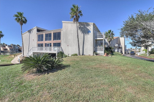 rear view of property featuring a yard