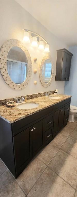 13757 Cayo Gorda Ct, Corpus Christi, TX 78418 - full bath with double vanity and tile patterned floors