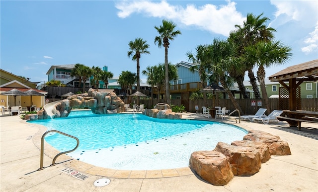 view of pool featuring pool water feature and a patio