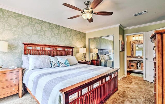 bedroom featuring visible vents, light colored carpet, crown molding, and wallpapered walls